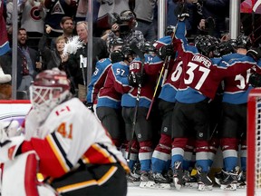 DENVER, COLORADO - APRIL 17:  Members of the Colorado Avalanche celebrate their overtime win over the Calgary Flames during Game Four of the Western Conference First Round during the 2019 NHL Stanley Cup Playoffs at the Pepsi Center on April 17, 2019 in Denver, Colorado. (Photo by Matthew Stockman/Getty Images)
