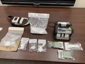 Drugs, cash and a hydraulic press were seized from a rural home by Airdrie Mounties.