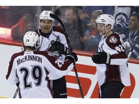 Colorado Avalanche's Nathan MacKinnon (29), Jarome Iginla (12) and Gabriel Landeskog (92) celebrate Iginla's goal against the Winnipeg Jets during first period NHL action in Winnipeg on Friday, December 5, 2014.