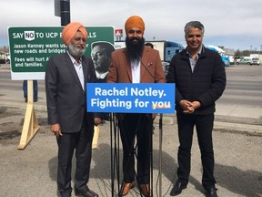 New Democratic Party candidates Parmeet Singh (centre), Gurbachan Brar and current MLA Irfan Sabir joined truck drivers on Sunday to protest Jason Kenney's supposed plan to toll new road infrastructure across the province.