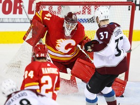 Calgary Flames goalie Mike Smith makes a save on a shot by Colorado Avalanche in Game One of the Western Conference First Round during the 2019 NHL Stanley Cup Playoffs at the Scotiabank Saddledome in Calgary on Thursday, April 11, 2019. Al Charest/Postmedia