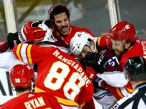 Calgary Flames Travis Hamonic and Oscar Fantenberg in the middle scrum after the whistle in game two of the Western Conference First Round during the 2019 NHL Stanley Cup Playoffs at the Scotiabank Saddledome in Calgary on Saturday, April 13, 2019. Al Charest/Postmedia