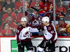 Colorado Avalanche Nathan MacKinnon celebrates with teammate Gabriel Landeskog  after scoring the overtime winner against the Calgary Flames in game two of the Western Conference First Round during the 2019 NHL Stanley Cup Playoffs at the Scotiabank Saddledome in Calgary on Saturday, April 13, 2019. Al Charest/Postmedia