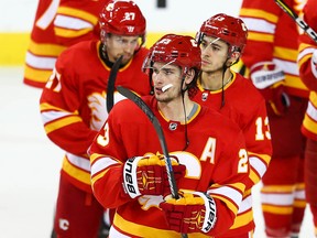 Calgary Flames Austin Czarnik, Sean Monahan and Johnny Gaudreau after losing game five of the Western Conference First Round during the 2019 NHL Stanley Cup Playoffs at the Scotiabank Saddledome in Calgary on Friday, April 19, 2019. Al Charest/Postmedia