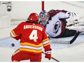 The Calgary Flames' Rasmus Andersson scores on Colorado Avalanche goaltender Philipp Grubauer during Game 2 Stanley Cup playoff action in Calgary on Saturday April 13. Photo by Gavin Young/Postmedia.