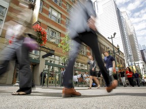 A lunch-hour crowd walks along Stephen Avenue in Calgary on July 22, 2014.