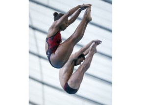 Canada's Jennifer Abel, left, and Canada's Francois Imbeau-Dulac compete during the mixed 3-metre synchro finals event at the FINA Diving Grand Prix in Calgary, Alta., Sunday, April 7, 2019.