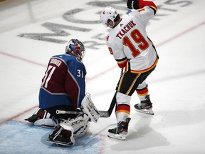 Colorado Avalanche goaltender Philipp Grubauer, left, stops a redirected shot by Calgary Flames left wing Matthew Tkachuk in overtime of Game 4 of an NHL hockey playoff series Wednesday, April 17, 2019, in Denver. The Avalanche won 3-2. (AP Photo/David Zalubowski) ORG XMIT: CODZ137