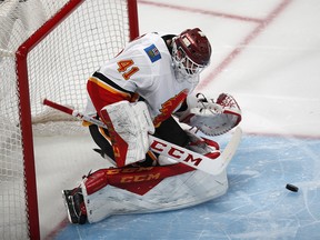 Calgary Flames goaltender Mike Smith stops a shot by the Colorado Avalanche in the first period of Game 3 of a first-round NHL hockey playoff series Monday, April 15, 2019, in Denver. (AP Photo/David Zalubowski) ORG XMIT: CODZ107