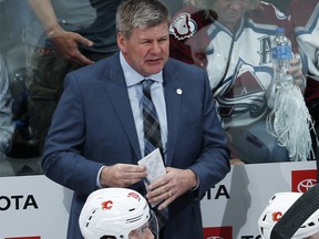 Calgary Flames head coach Bill Peters looks on in the first period of Game 3 of a first-round NHL hockey playoff series against the Colorado Avalanche, Monday, April 15, 2019, in Denver. (AP Photo/David Zalubowski) ORG XMIT: CODZ108