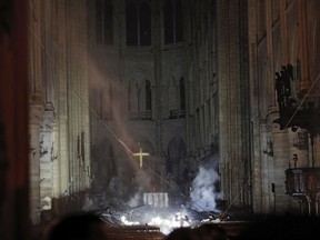 Smoke is seen in the interior of Notre Dame cathedral in Paris, Monday, April 15, 2019. A catastrophic fire engulfed the upper reaches of Paris' soaring Notre Dame Cathedral as it was undergoing renovations Monday, threatening one of the greatest architectural treasures of the Western world as tourists and Parisians looked on aghast from the streets below.