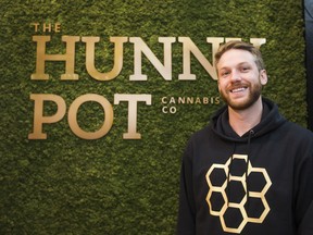 Cameron Brown, communications officer for The Hunny Pot Cannabis Co., in front of the moss wall inside the store located along Queen St. W. in Toronto.