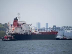 Tug boats prepare a oil tanker to go under the Second Narrows bridge after it left Kinder Morgan marine terminal in Burrard Inlet just outside of metro Vancouver, B.C.