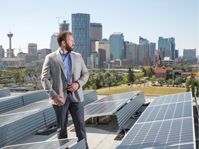 Mike Bucci on the roof of Radius in Bridgeland with solar panels.