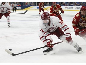 Massachusetts defenseman Cale Makar (16) controls the puck during the second period in a semifinal against Denver during the Frozen Four NCAA men's college hockey tournament Thursday, April 11, 2019, in Buffalo, N.Y.