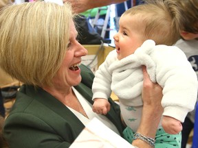 Alberta NDP Leader Rachel Notley holds Maia Louro, 4 months,  during a campaign stop at Expanding Imaginations Child Care in Calgary on Wednesday, April 10, 2019.