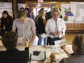 Alberta NDP Leader Rachel Notley and her son Ethan Arab vote in the provincial election in Edmonton on Tuesday, April 16, 2019.