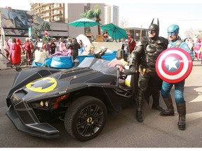Batman poses for a photo with Captain America during the annual Parade of Wonders that kicks off the 2019 Calgary Comic Expo Friday, April 26, 2019.