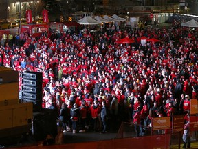 Flames fans react to the action on a giant outdoor TV as thousands join the C of Red to watch Game 5 at the "Red Lot" community viewing party outside the Dome. Friday, April 19, 2019.