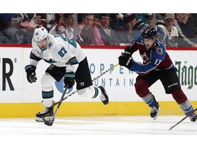 San Jose Sharks right wing Joonas Donskoi, left, drives down the ice with the puck past Colorado Avalanche center Alexander Kerfoot in the second period of an NHL hockey game Wednesday, Jan. 2, 2019, in Denver.