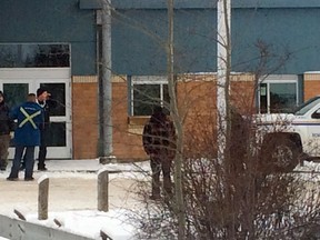 Officials stand outside of La Loche Community School after a deadly multiple-shooting on Friday, Jan. 22, 2016.