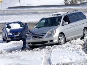 Drivers return to their abandoned vehicles along Shaganappi Trail N.W. near Country Hills Drive on Sunday, April 28, 2019, after a fierce storm the night before.