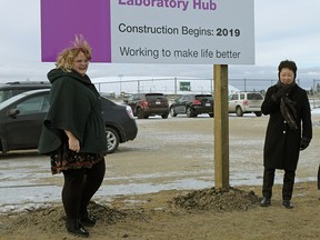 Former Health Minister Sarah Hoffman (left) and Dr. Verna Yu, President and CEO of Alberta Health Services unveil the location for a new integrated public lab facility in Edmonton on Dec. 21, 2017.