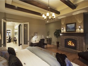 The ceiling details add ambience to a bedroom in a home by Wolf Custom Homes.