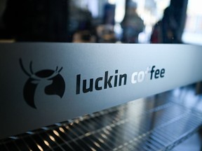 A logo of Luckin Coffee is seen at a store in Beijing on January 4, 2019. - After only a year in business, startup Luckin Coffee said on January 3 it will open 2,500 stores this year to dislodge Starbucks and become China's largest coffee chain.