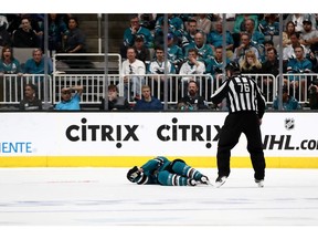 SAN JOSE, CALIFORNIA - APRIL 23:  Joe Pavelski #8 of the San Jose Sharks lies on the ice after a hard hit by the Vegas Golden Knights in the third period in Game Seven of the Western Conference First Round during the 2019 NHL Stanley Cup Playoffs at SAP Center on April 23, 2019 in San Jose, California.