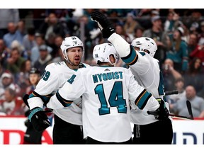 DENVER, COLORADO - APRIL 30: Gustav Nyqvist #14 of the San Jose Sharks is congratulated by Logan Couture #39 and Marc-Edouard Vlasic #44 after scoring a goal to regain the lead against the Colorado Avalanche in the third period during Game Three of the Western Conference Second Round during the 2019 NHL Stanley Cup Playoffs at the Pepsi Center on April 30, 2019 in Denver, Colorado.