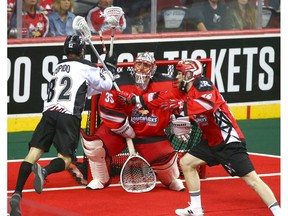 Roughnecks keeper Christian Del Bianco (C) stand his ground in net as Mammoth Joey Cupido takes a shot during National Lacrosse League West Division final action between the Calgary Roughnecks and Colorado Mammoth in Calgary on Friday, May 10, 2019. Jim Wells/Postmedia