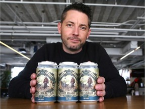 Adrian Di Marino poses with cans of Fort Calgary ISA. His brewrey has reached an agreement with the city to sell of the last of the beer.