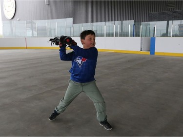 Kayson Dodging Horse, 5, practises lacrosse in the covered outdoor rink at the newly opened Tsuut'ina Seven Chiefs Sportsplex and Chief Jim Starlight Centre on Tuesday May 21, 2019. Gavin Young/Postmedia