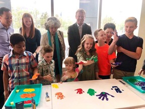 Kids covers their hands in paint and are joined by dignitaries for the announcement of a $3.9 million donation for a pediatric emergency care space at the South Health Campus in Calgary on Friday, May 31, 2019.