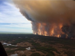 The Chuckegg Creek fire is seen from the air in a Government of Alberta handout photo taken near the town of High Level on Sunday, May 19, 2019.