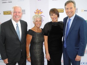 With Turning Points co-chairs Shelly Norris (second from left) and Sherri Logel are their proud husbands Alan Norris (left) and Tim Logel.