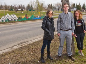 Artists Lee-Ann Lukacs, left and Kelli Robinson stand with Mark Schmidt, Mindapore Sundance Community Association President across the street from a public art installation on the fence dividing Sun Valley Blvd S.E. on Wednesday May 8, 2019. The community conceived, funded and installed the art. Gavin Young/Postmedia