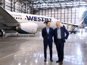 Tawfiq Popatia, a managing director at Onex, left, stands with WestJet President and CEO Ed Sims next to Boeing 737 and 787 Dreamliner aircraft in one of WestJet's Calgary hangers on Monday May 13, 2019.