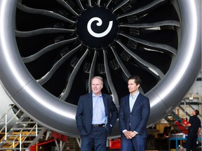 WestJet president and CEO Ed Sims, left, and Tawfiq Popatia, a managing director at Onex, stand next to one of the engines of a Boeing 787 Dreamliner in a WestJet hanger on Monday, May 13, 2019.