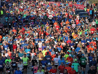 Runners in the Scotiabank Calgary Marathon and Half Marathon race off the start at Stampede Park on Sunday May 26, 2019.