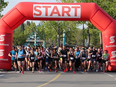 Runners in the Jugo Juice 10 K event at the Scotiabank Calgary Marathon race off the start at Stampede Park on Sunday May 26, 2019.