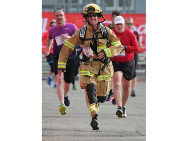 Calgary firefighter Tim Dickenson runs in fire gear during the Jugo Juice 10K one of the events at the Scotiabank Calgary Marathon on Sunday May 26, 2019. Dickenson was one of several firefighters running and raising money for the Calgary Firefighters Charitable Foundation.