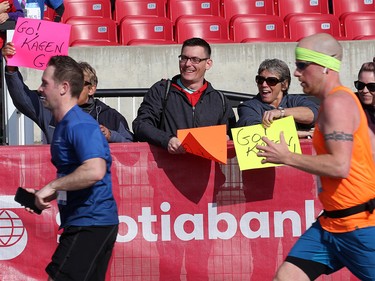 Friends and family cheer on runners during the Scotiabank Calgary Marathon at Stampede Park on Sunday May 26, 2019.