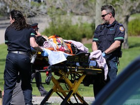 Paramedics with a patient at the scene of a collision on McKnight Boulevard Monday afternoon.