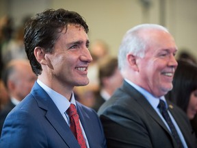 Oct. 2, 2018, photo showing Prime Minister Justin Trudeau and B.C. Premier John Horgan at a news conference announcing that LNG Canada is moving ahead with plans to build an export facility at Kitimat, B.C.