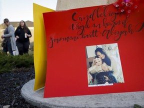Mourners attend a candlelight vigil for double-homicide victims Jasmine Lovett and her 22-month-old daughter, Aliyah Sanderson, in a Cranston park on Sunday.