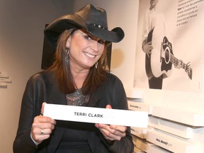 Canadian country music star Terri Clark placed a plaque on the wall to honour her induction into the Country Music Hall of Fame at the National Music Centre in Calgary  in 2019.