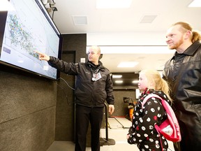 Nine-year-old Maria and her father Nik are shown tornado activity in Alberta by assistant chief Coby Duerr in the new Calgary Emergency Management Agency Mobile Centre during the annual Disaster Alley preparedness event at McMahon Stadium. Saturday, May 4, 2019.