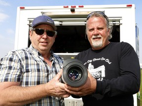 Wes Shaw, left, and Jeff Langford in 2019 with the projector and decommissioned ambulance they had planned use for a drive-in near High River.